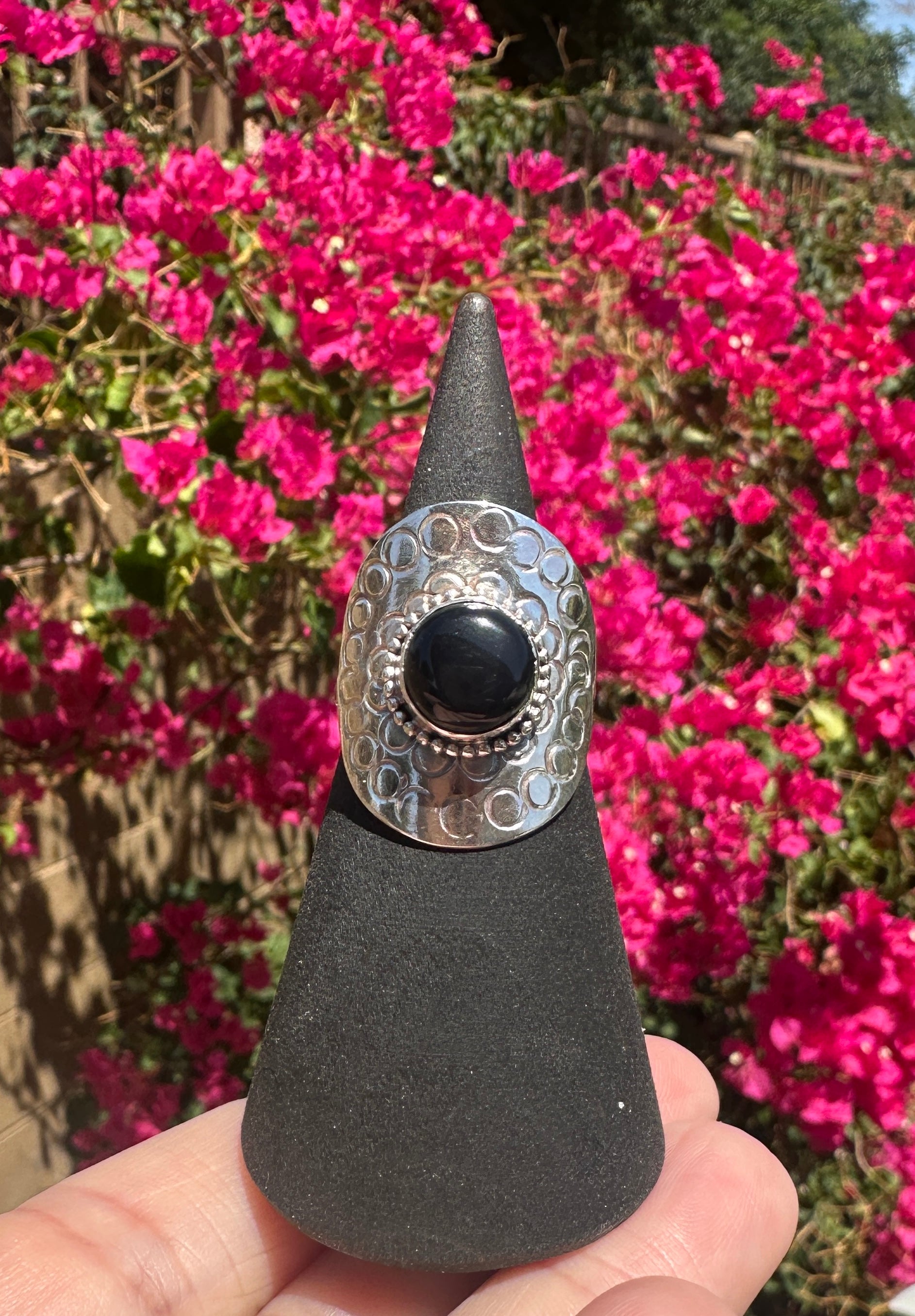 Onyx encircled by silver ring