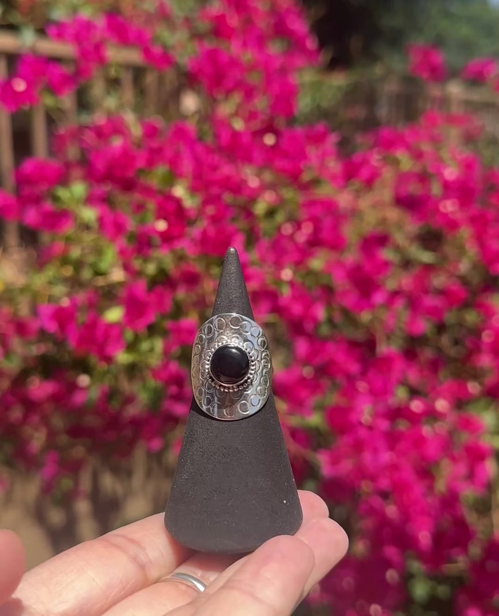 Onyx encircled by silver ring